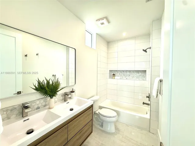 a view of a bathroom from a hallway