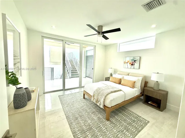 a bedroom with a bed and glass walk in closet