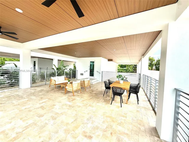 a swimming pool with a yard and palm trees