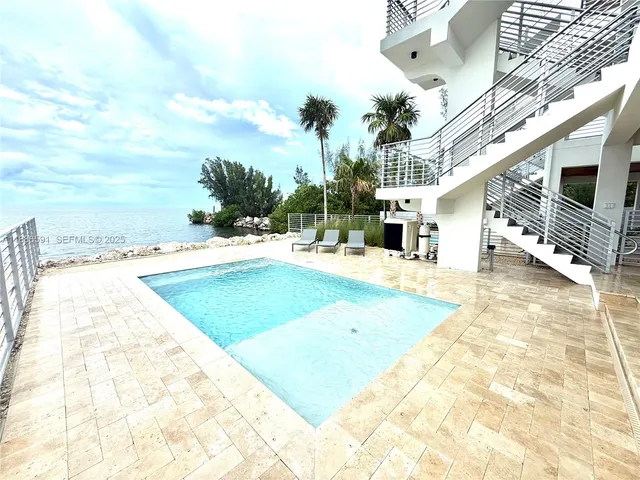a view of a building with yard and sitting area
