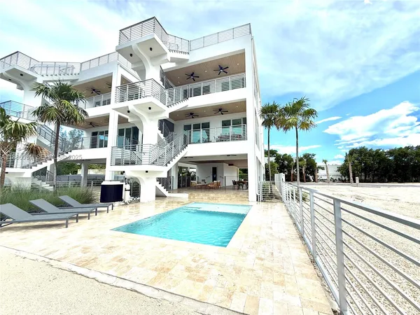 a swimming pool with outdoor seating and yard