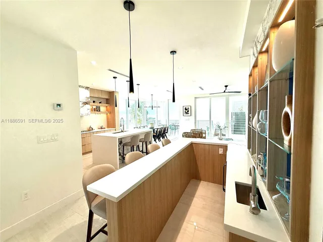 a view of living room with kitchen island furniture and a floor to ceiling window