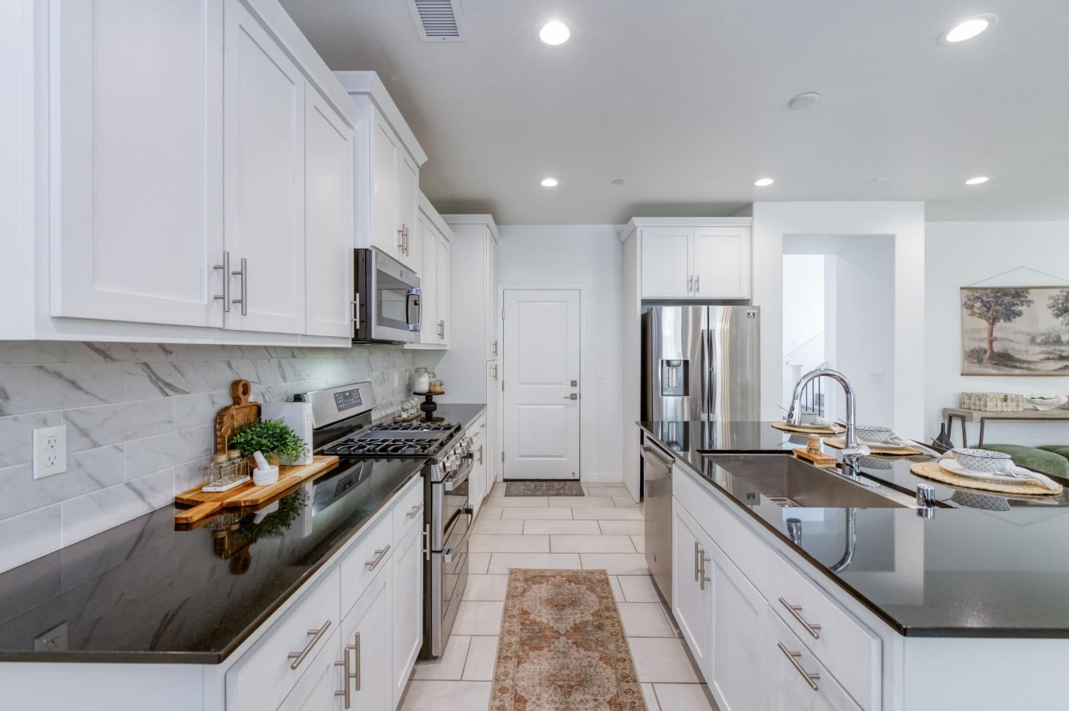 4670 Terrace Road Madera, CA 93636 - Photo 13 of 53 a kitchen with stainless steel appliances granite countertop a sink stove and refrigerator
