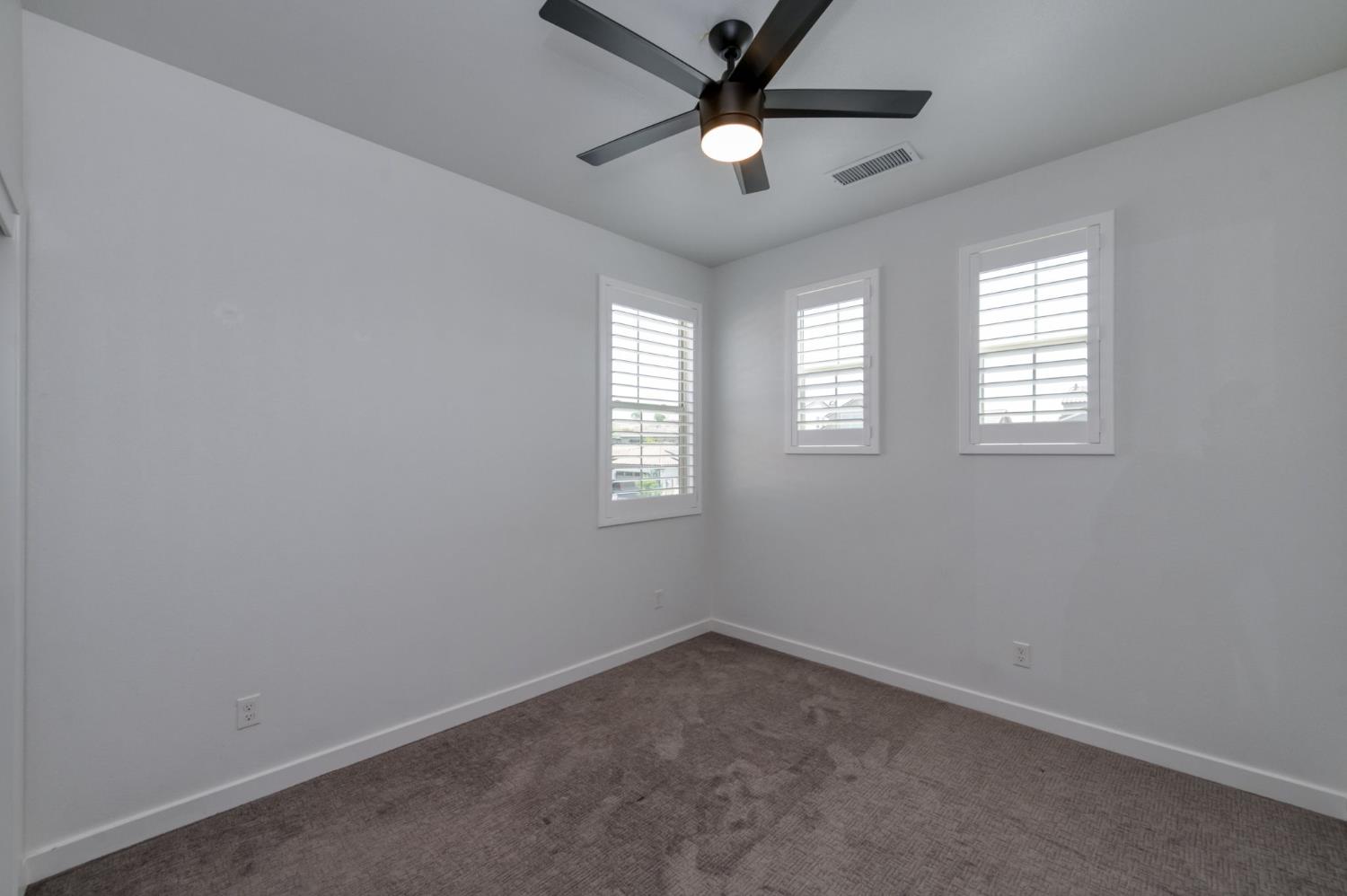 4670 Terrace Road Madera, CA 93636 - Photo 22 of 53 an empty room with a window and a fan