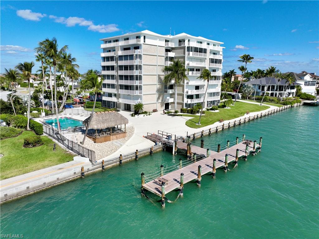 60 West Pelican Street, Unit 505 Naples, FL 34113 - Photo 1 of 41 a multi story pool table and chairs with the ocean view