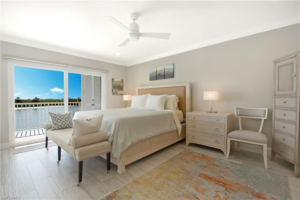 60 West Pelican Street, Unit 505 Naples, FL 34113 - Photo 11 of 41 a bedroom with furniture and a large window