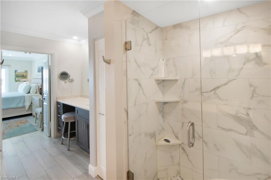 60 West Pelican Street, Unit 505 Naples, FL 34113 - Photo 13 of 41 a en suite bathroom with a shower