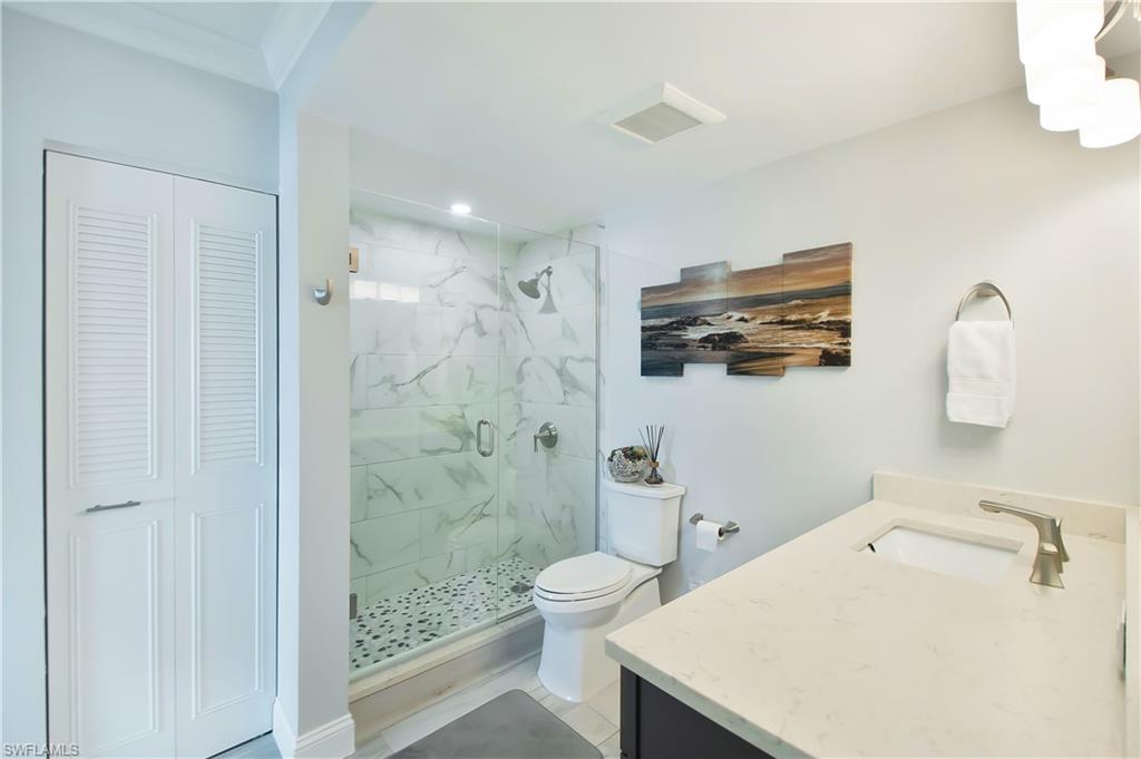 60 West Pelican Street, Unit 505 Naples, FL 34113 - Photo 14 of 41 a bathroom with a sink a toilet and shower