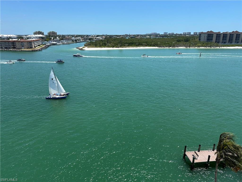 60 West Pelican Street, Unit 505 Naples, FL 34113 - Photo 17 of 41 a view of a lake with houses in background