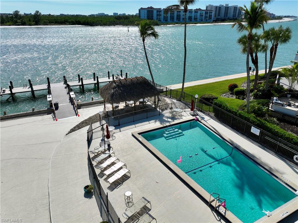 60 West Pelican Street, Unit 505 Naples, FL 34113 - Photo 20 of 41 a view of a swimming pool with chairs