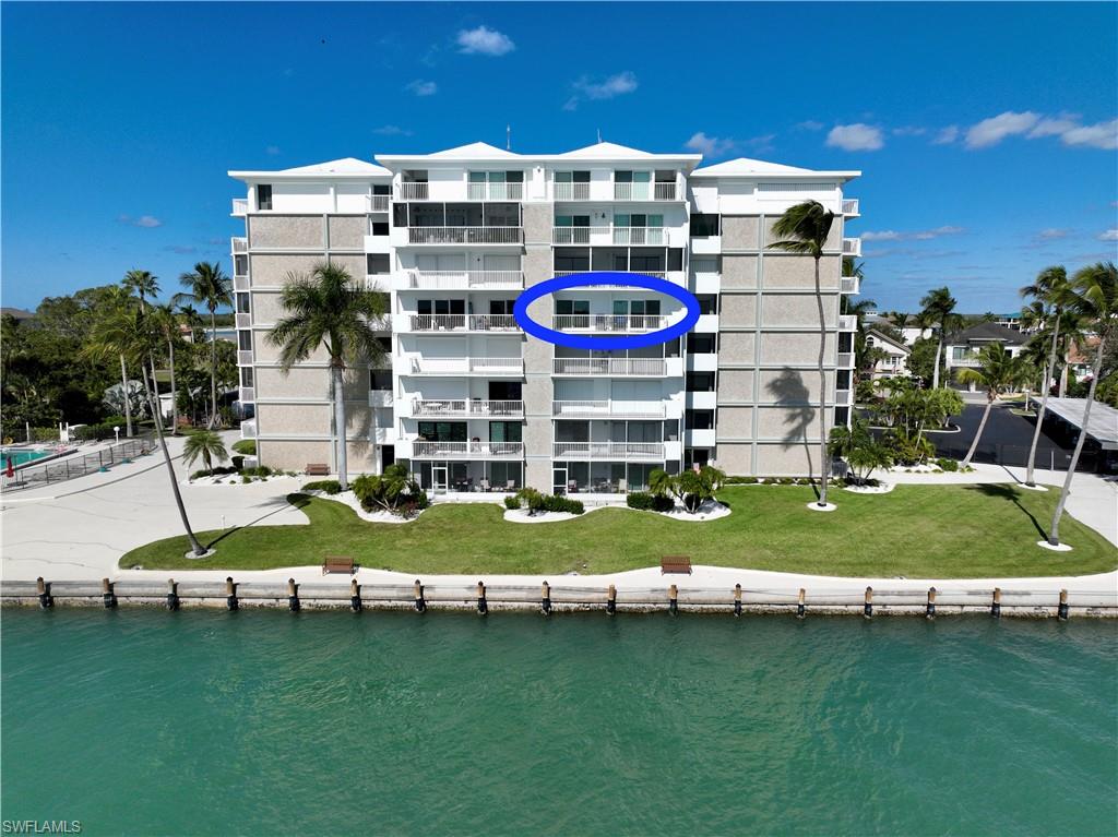 60 West Pelican Street, Unit 505 Naples, FL 34113 - Photo 2 of 41 a view of a building with a swimming pool