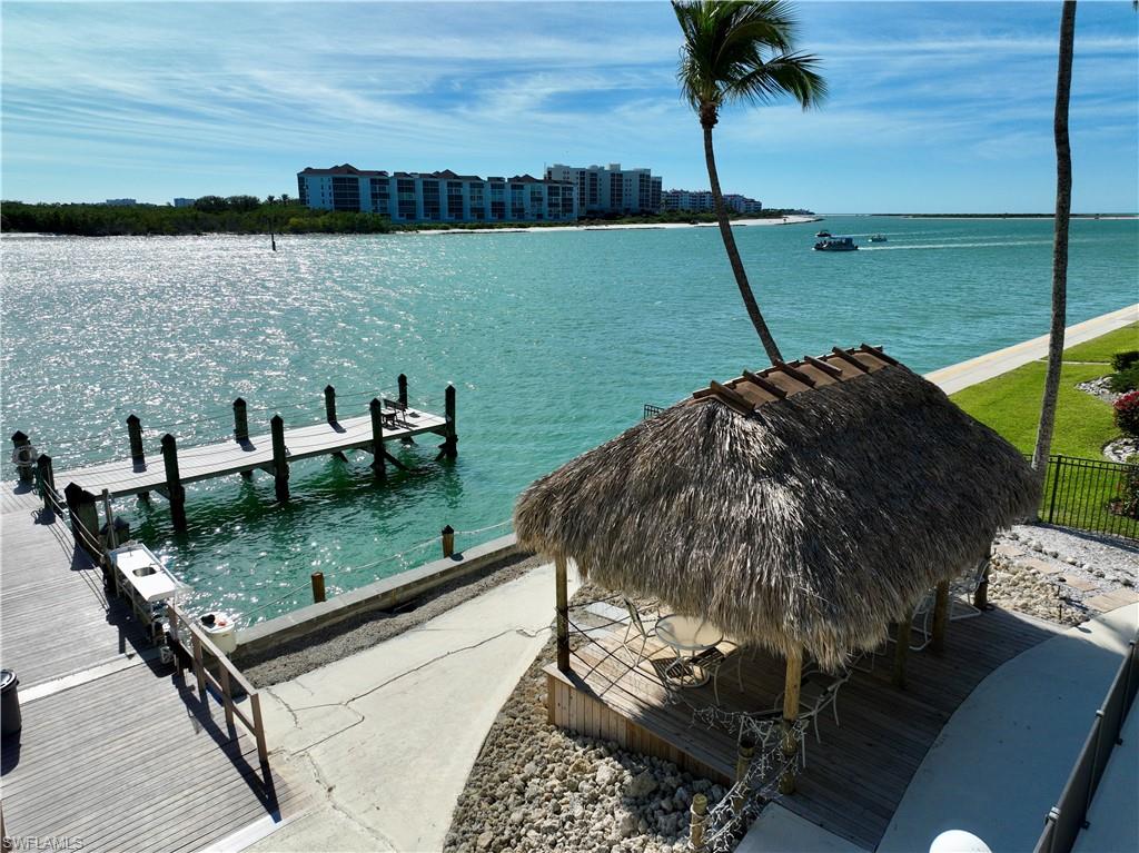 60 West Pelican Street, Unit 505 Naples, FL 34113 - Photo 21 of 41 a view of a lake with a bench and lake view