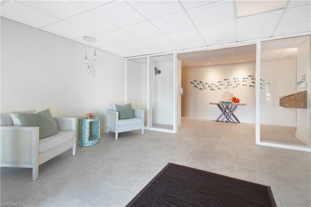 60 West Pelican Street, Unit 505 Naples, FL 34113 - Photo 37 of 41 a living room with furniture and white walls