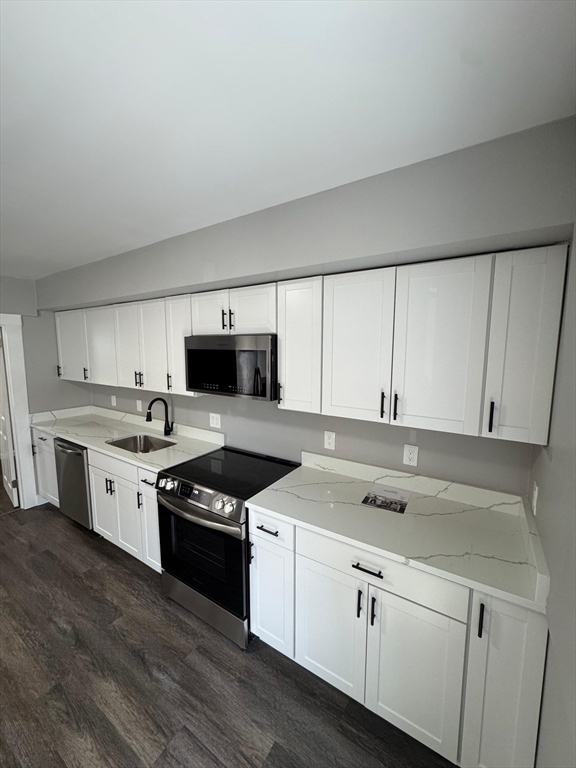 32 Main Street Monson, MA 01057 - Photo 6 of 42 a kitchen with white cabinets and appliances