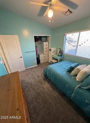 a bedroom with a bed and a large mirror