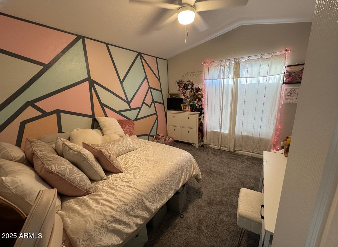 13781 West Vernon Avenue Goodyear, AZ 85395 - Photo 16 of 25 a bedroom with a bed a couch and chandelier