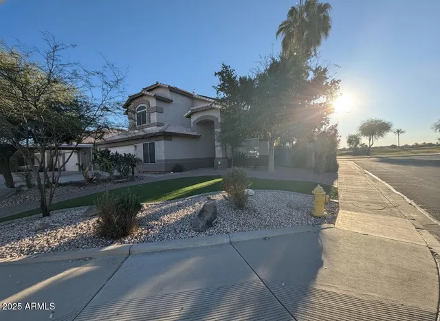 a front view of a house with a yard and a garage