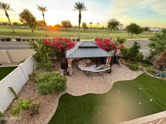 a view of a swimming pool with a patio and a garden