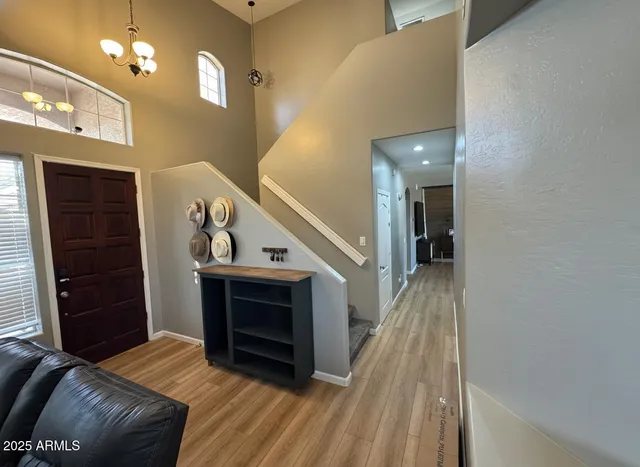 a view of entryway and hall with wooden floor