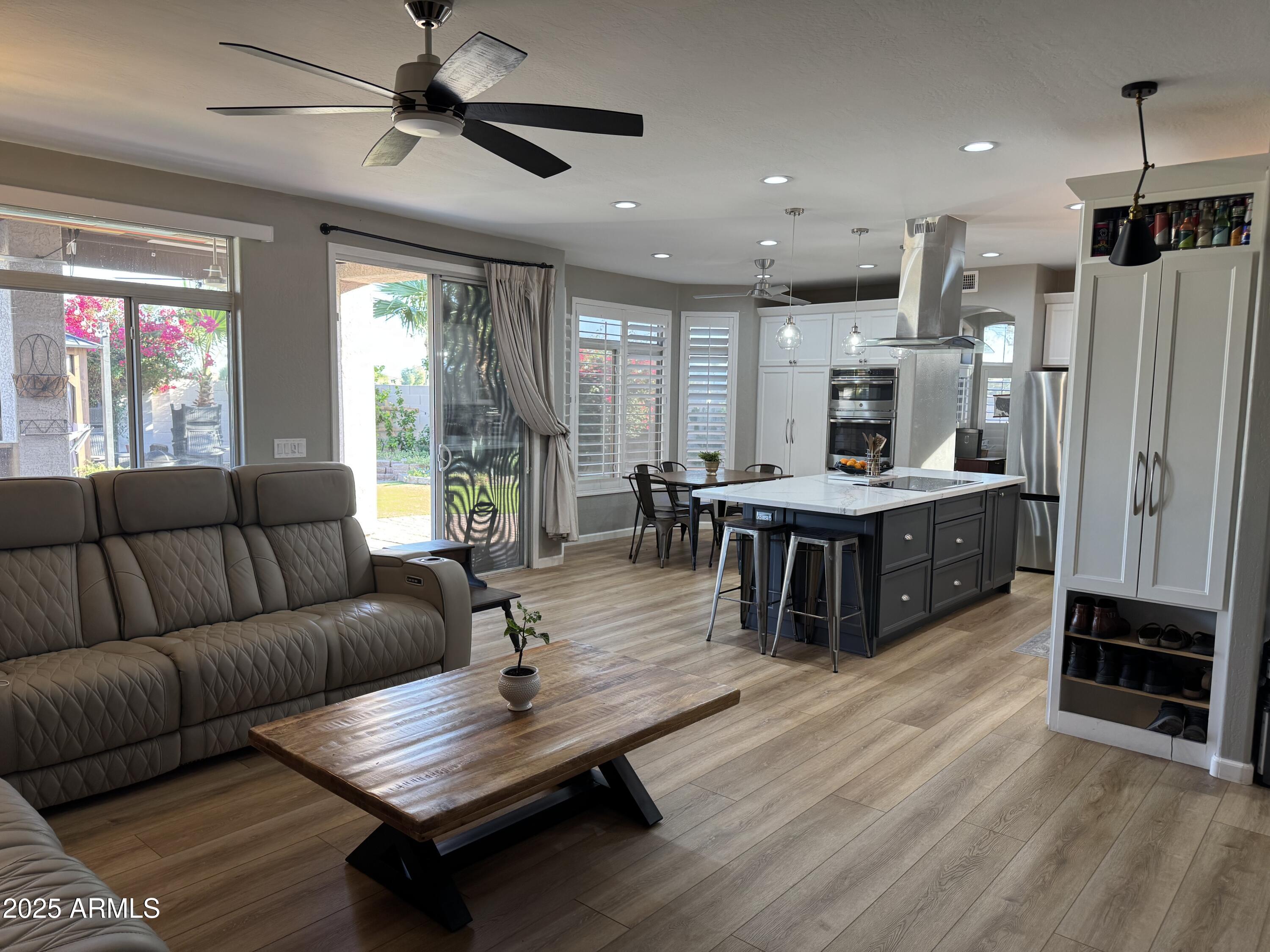13781 West Vernon Avenue Goodyear, AZ 85395 - Photo 6 of 25 a living room with furniture a ceiling fan and a window