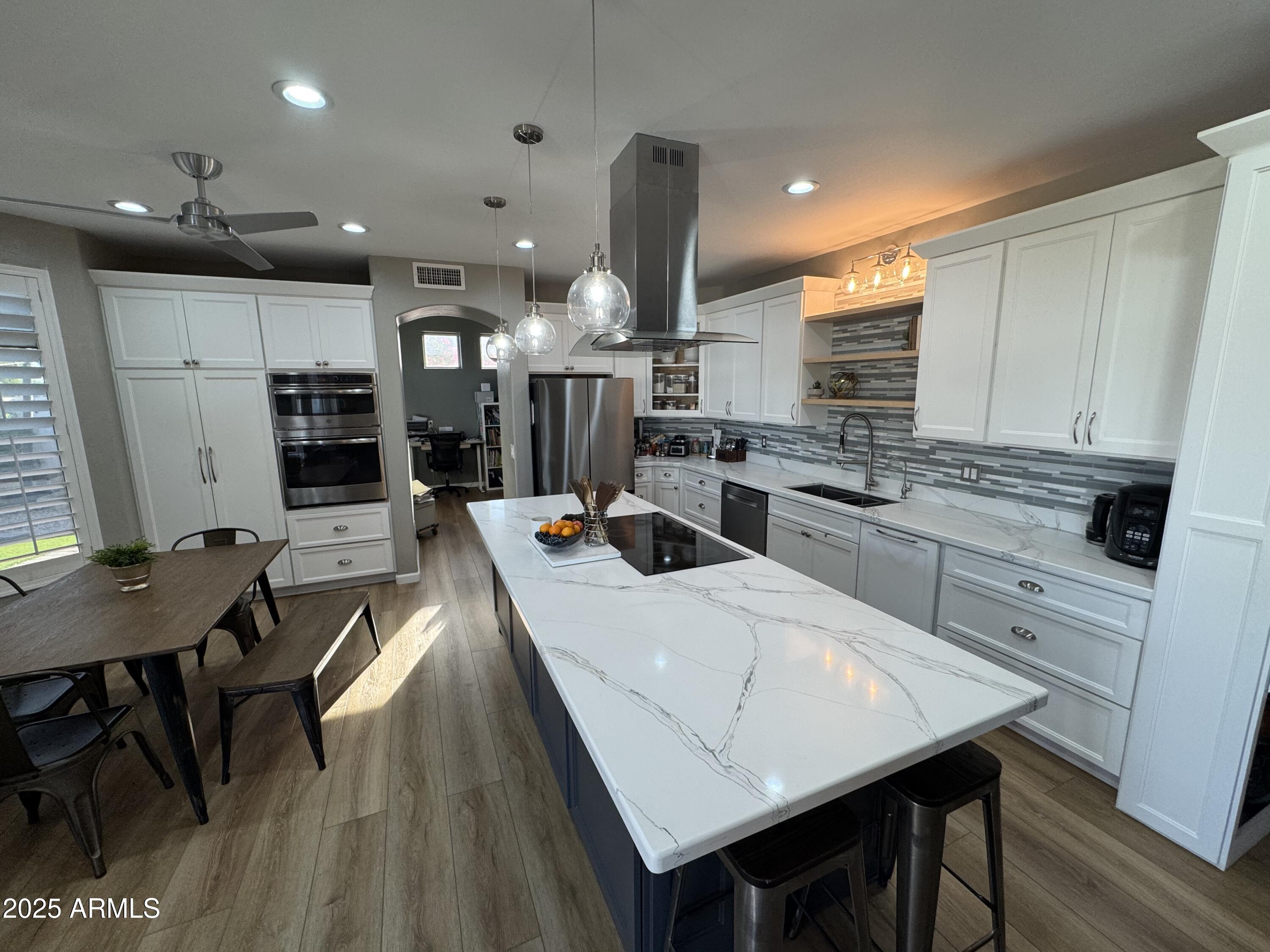 13781 West Vernon Avenue Goodyear, AZ 85395 - Photo 7 of 25 a large kitchen with a table and chairs
