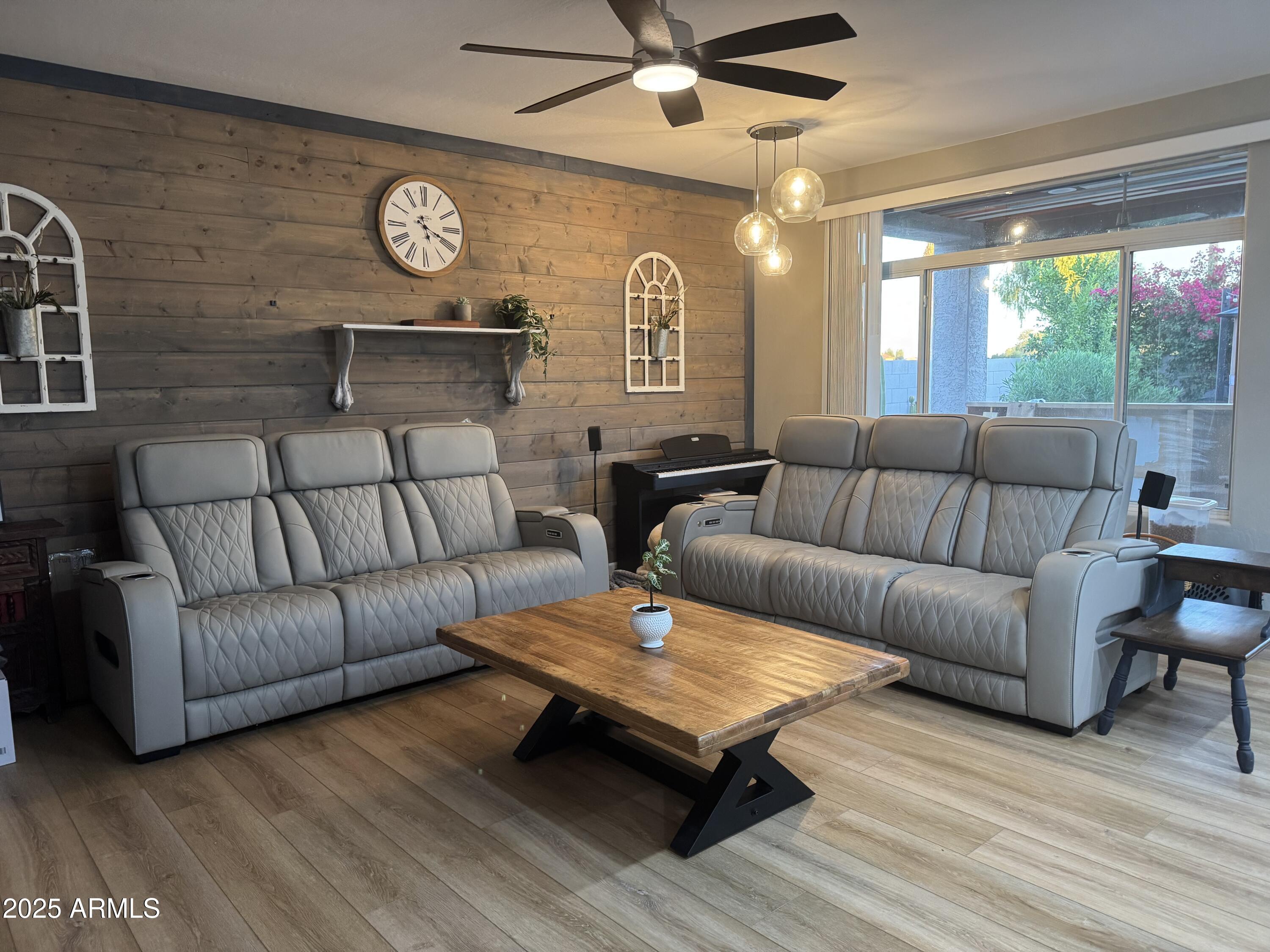 13781 West Vernon Avenue Goodyear, AZ 85395 - Photo 8 of 25 a living room with furniture a wooden floor and a large window