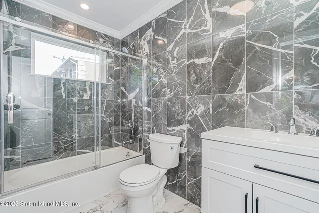 a bathroom with a shower toilet and sink