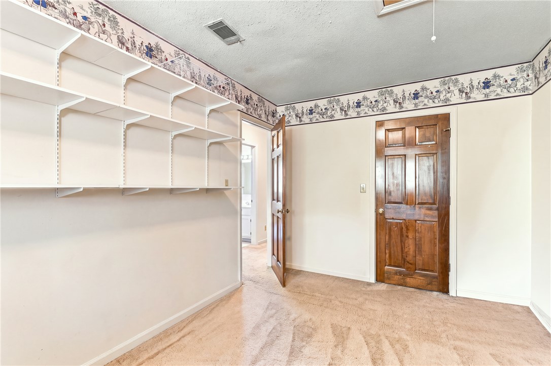 7 Woodbridge Circle Anderson, SC 29621 - Photo 22 of 26 Adjustable built-in wall shelving complements classic paneled wood doors and plush carpeted flooring.