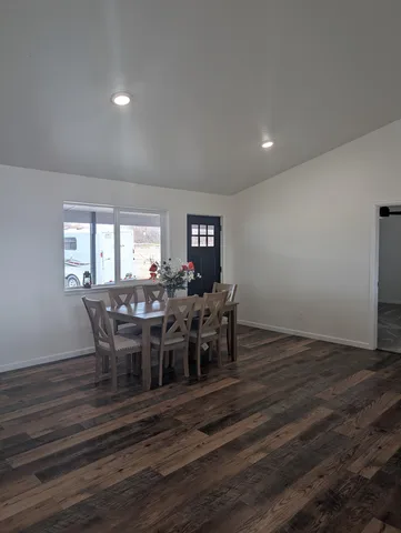 a view of a dining room with furniture and wooden floor