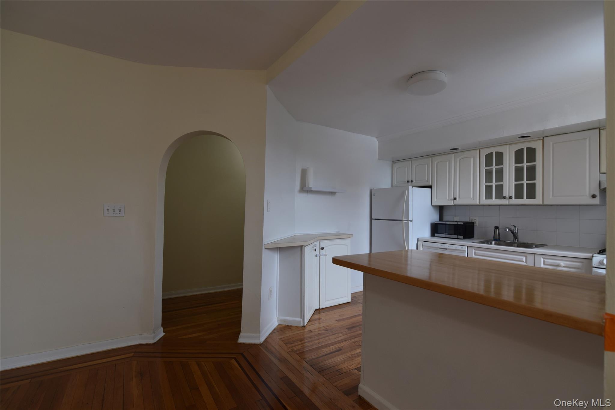 83-52 Talbot Street, Unit 5C Queens, NY 11415 - Photo 12 of 22 a kitchen with stainless steel appliances a sink stove and cabinets
