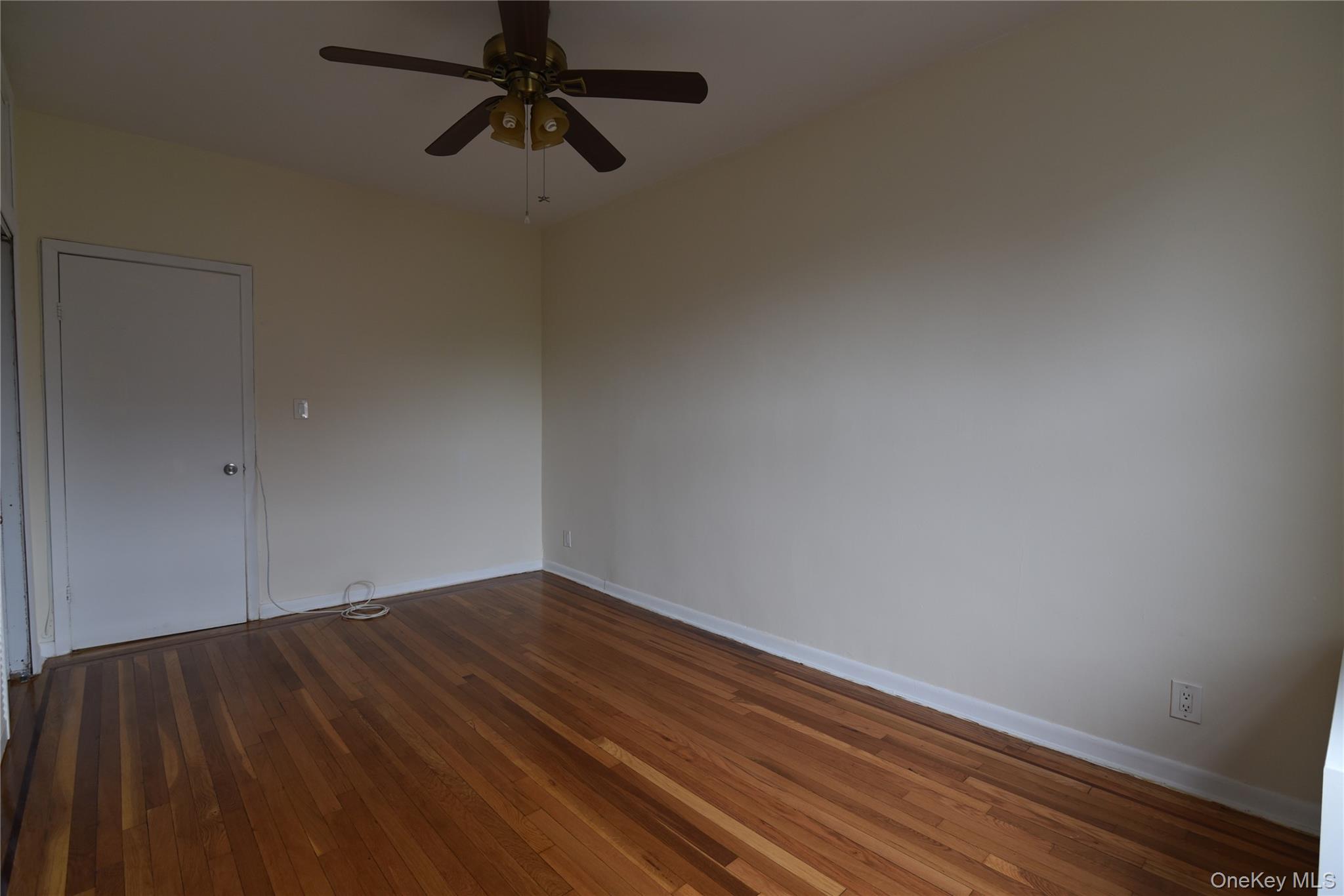 83-52 Talbot Street, Unit 5C Queens, NY 11415 - Photo 18 of 22 a view of a room with wooden floor