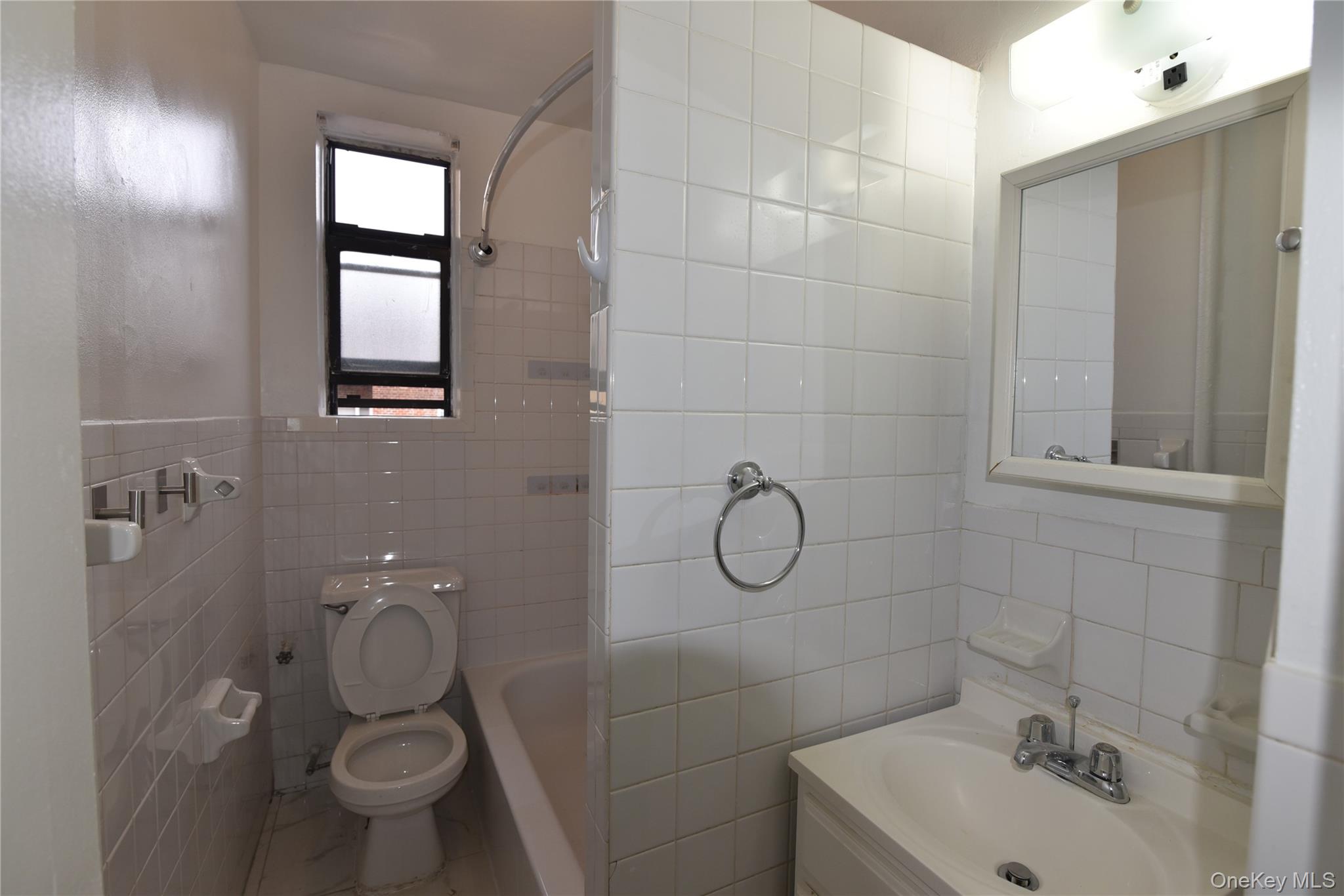 83-52 Talbot Street, Unit 5C Queens, NY 11415 - Photo 20 of 22 a bathroom with a toilet sink and shower