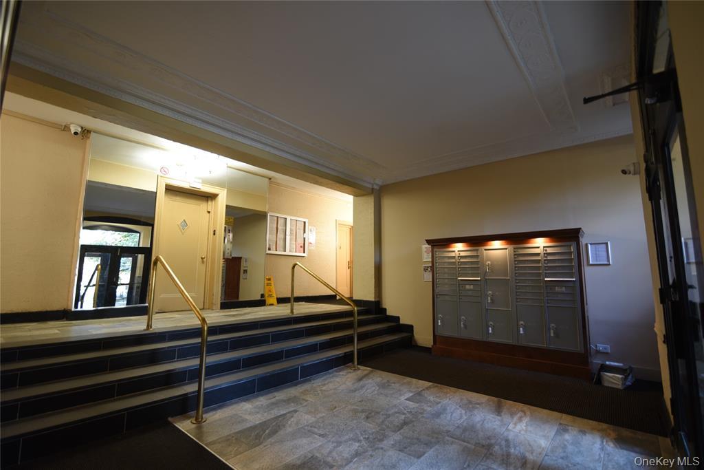 83-52 Talbot Street, Unit 5C Queens, NY 11415 - Photo 3 of 22 a room with stairs and wooden floor