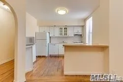 a view of kitchen with cabinets and wooden floor