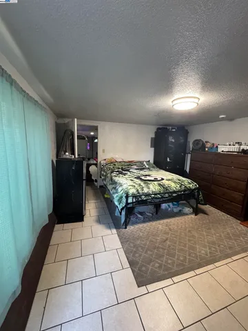 a bedroom with a bed and mirror