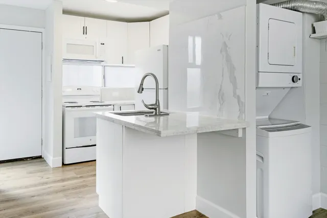 a kitchen with stainless steel appliances a sink stove and cabinets