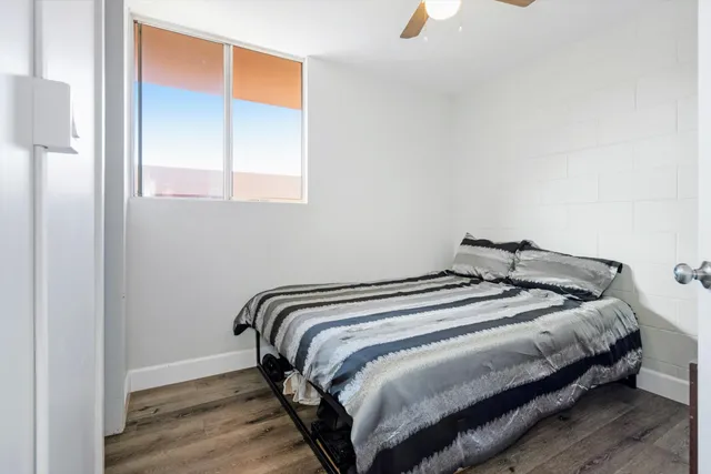 a bedroom with a bed and a window