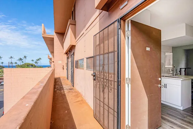 a view of balcony with wooden floor and fence