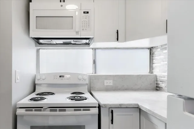 a kitchen with a stove and a cabinets