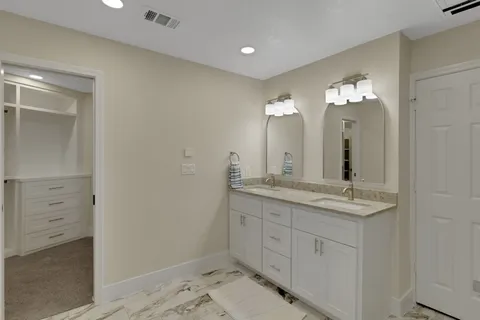 a bedroom with a bed and a couch
