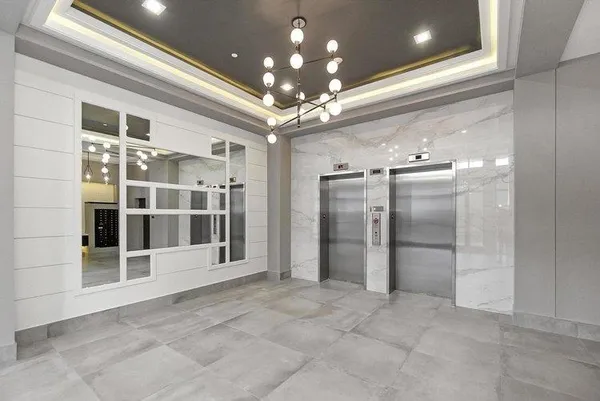 a view of a big room with chandelier windows and chandelier fan
