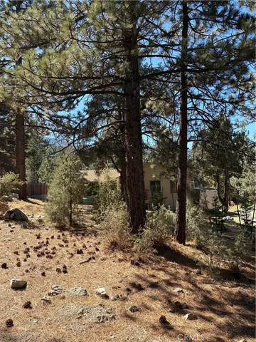 an empty room with a window and a ceiling fan