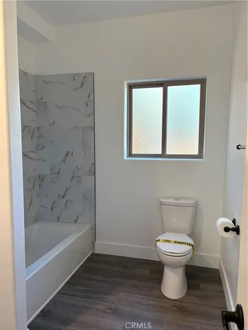 a bathroom with a tub sink and vanity