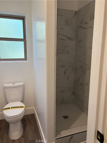 a bathroom with a sink toilet and a mirror