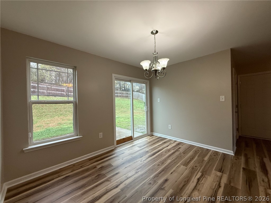 Undisclosed Address Spring Lake, NC 28390 - Photo 14 of 50 an empty room with wooden floor and windows