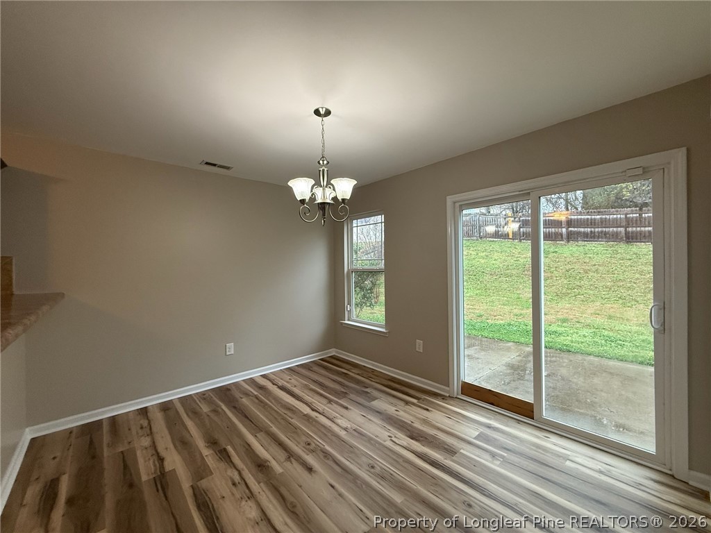 Undisclosed Address Spring Lake, NC 28390 - Photo 15 of 50 a view of wooden floor chandelier and window in a room