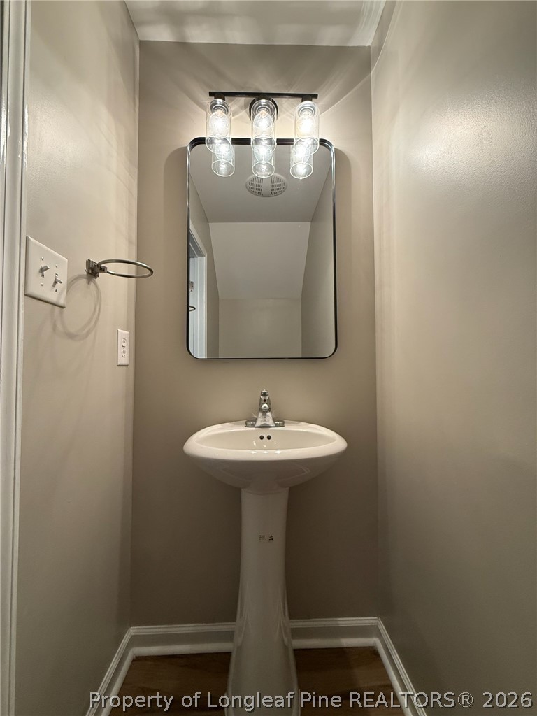 Undisclosed Address Spring Lake, NC 28390 - Photo 17 of 50 a bathroom with a sink and mirror
