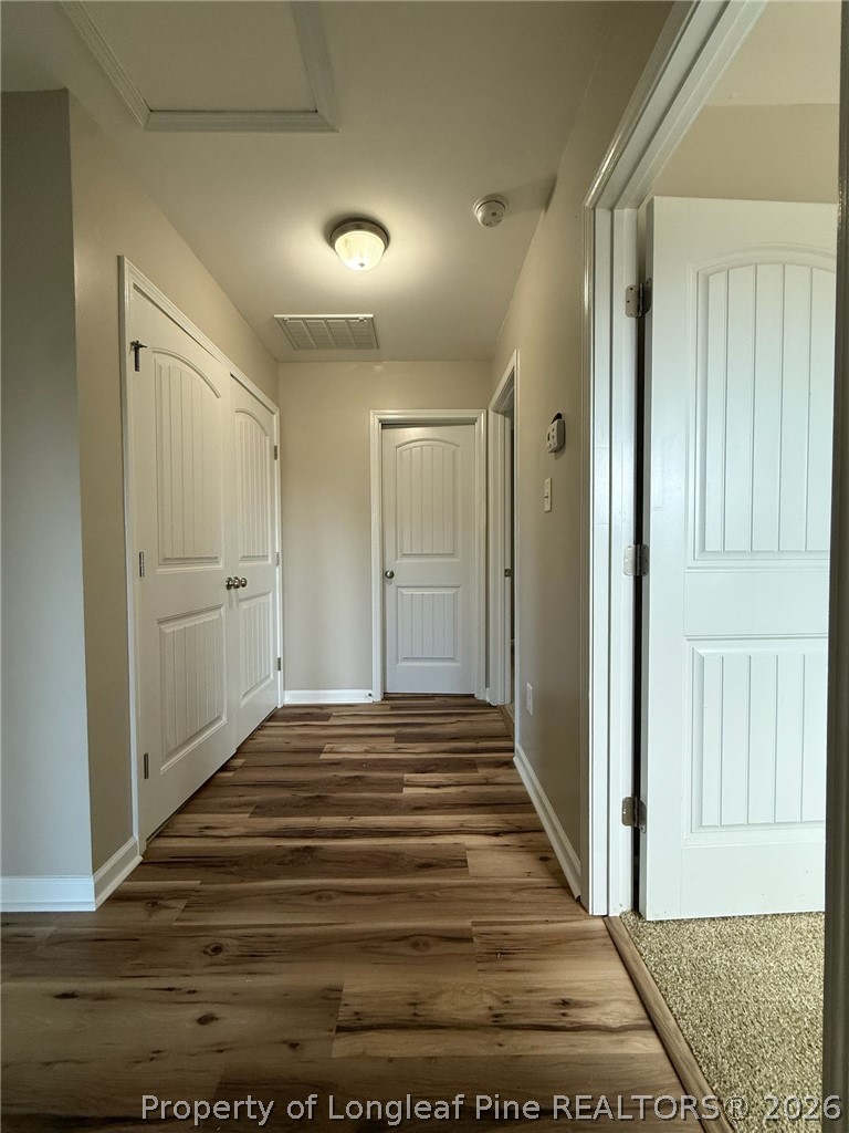 Undisclosed Address Spring Lake, NC 28390 - Photo 19 of 50 a view of a hallway with wooden floor and entryway