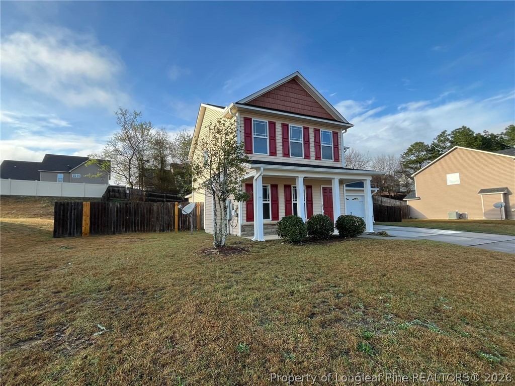 Undisclosed Address Spring Lake, NC 28390 - Photo 2 of 50 a front view of a house with garden