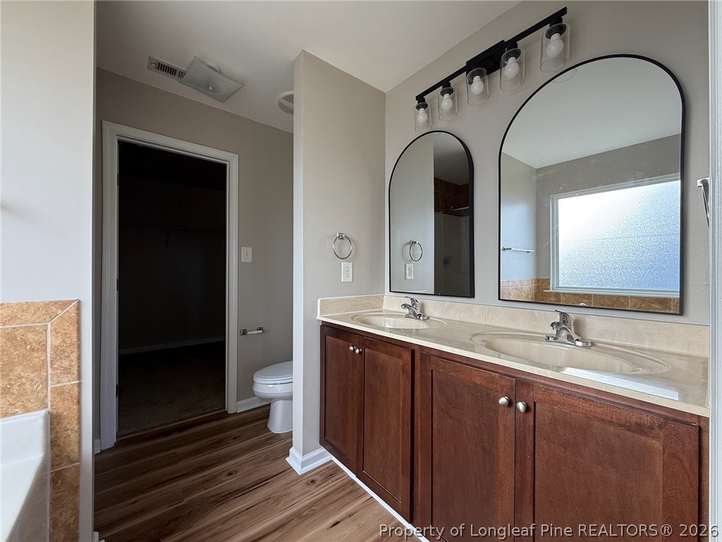 Undisclosed Address Spring Lake, NC 28390 - Photo 27 of 50 a bathroom with a double vanity sink and a toilet